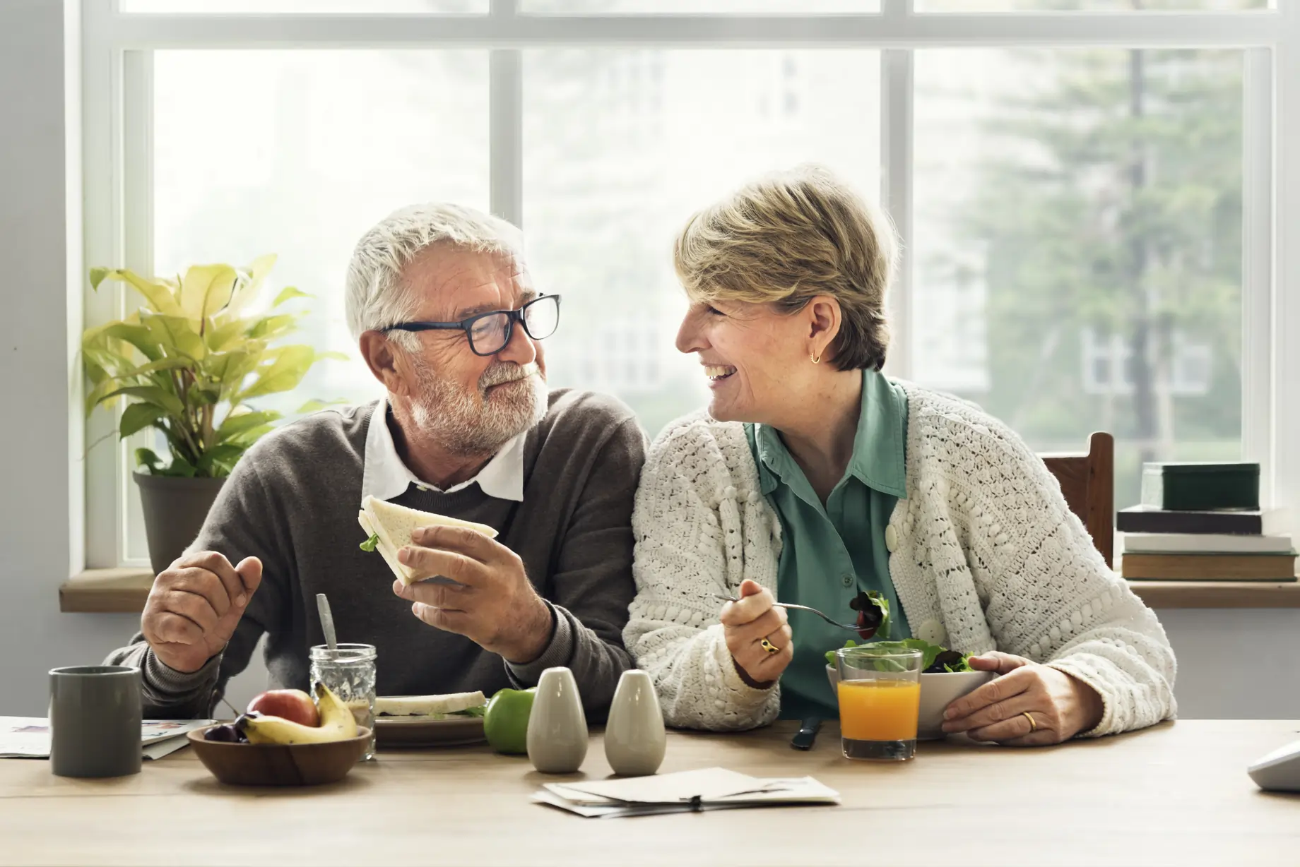 Elderly couple enjoying breakfast together.